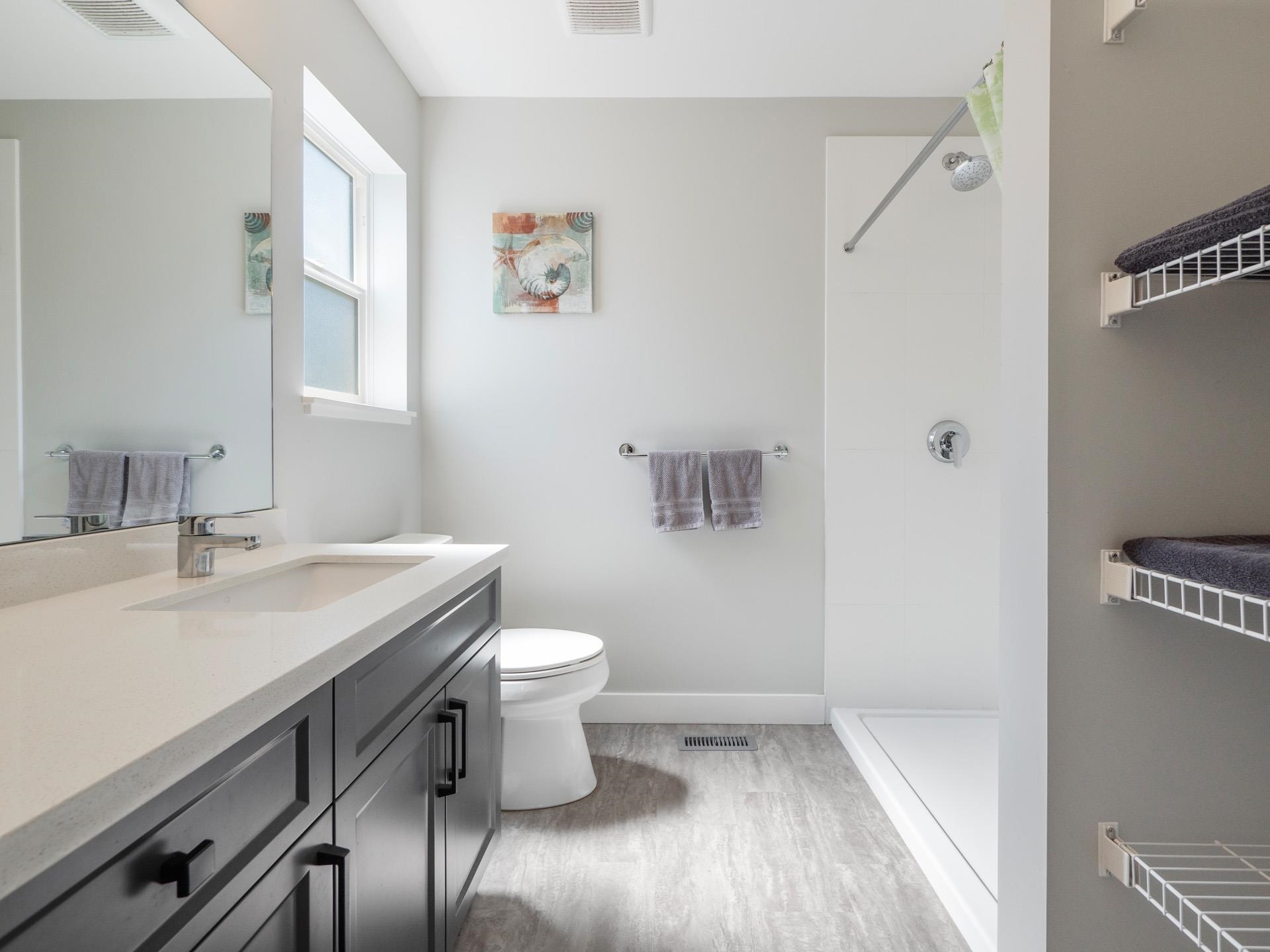 With double sized shower, quartz countertops, plenty of storage and big window