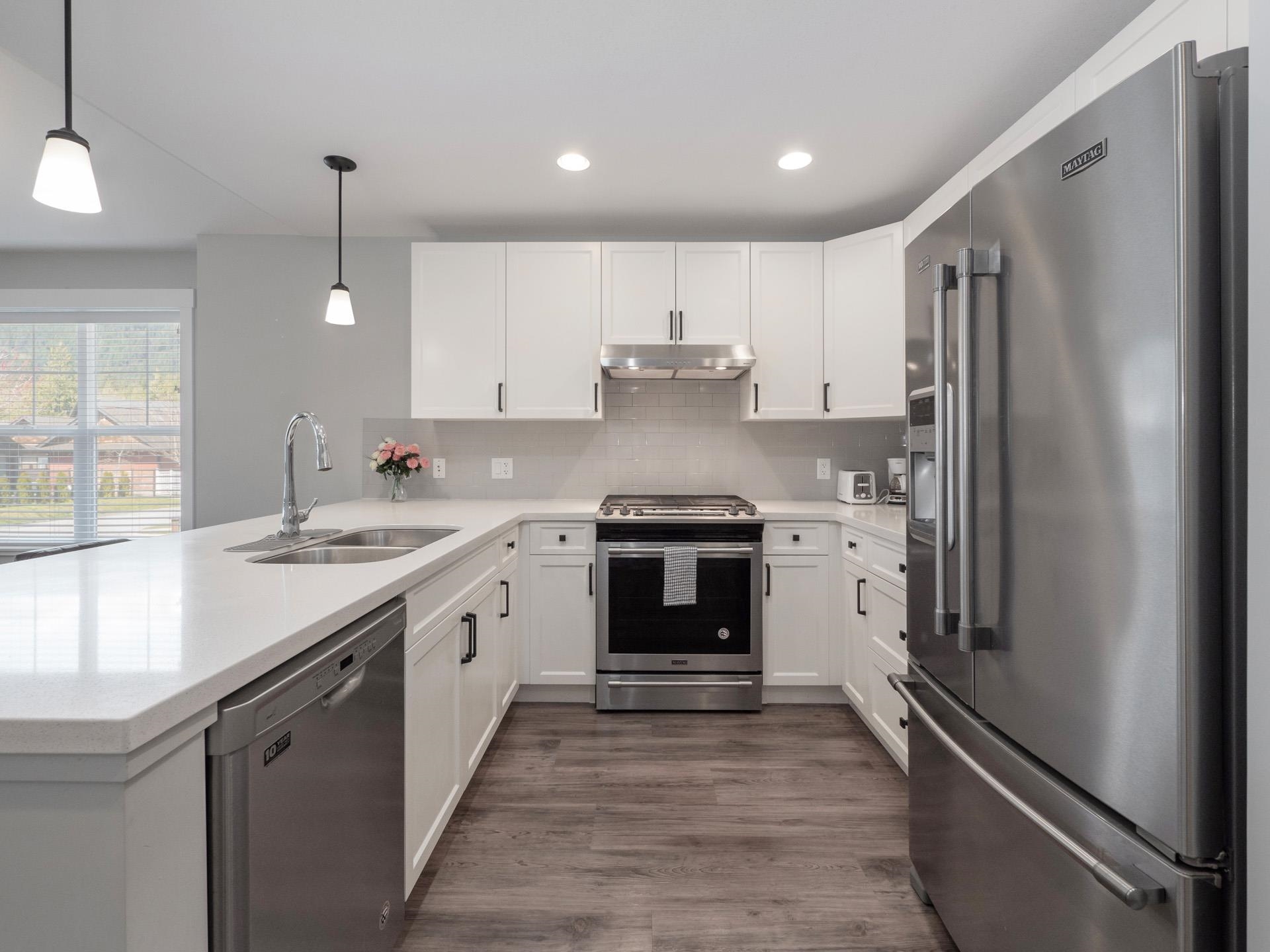 Natural gas range and quartz countertops.