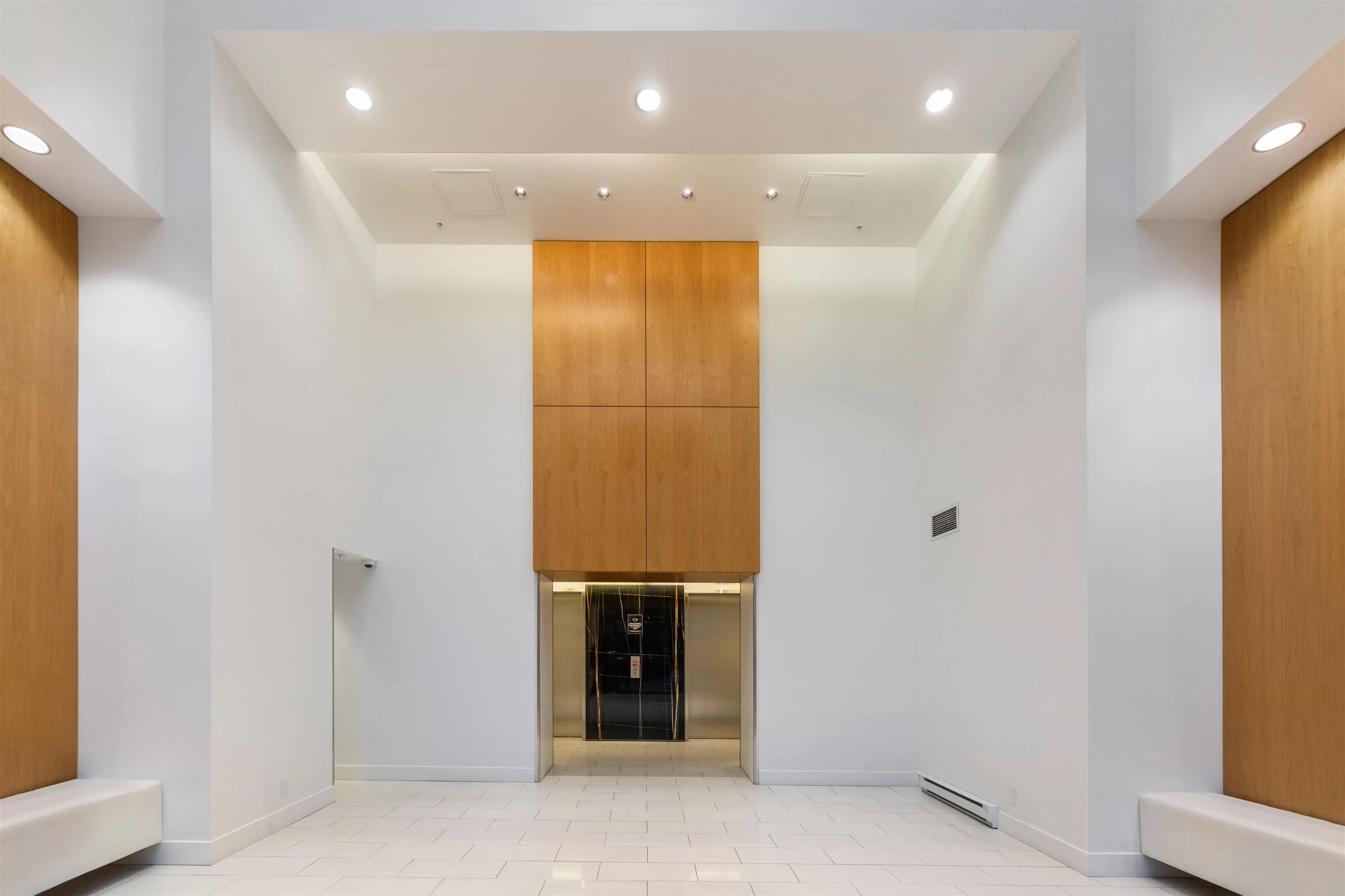 Impressive triple-height lobby.  Secondary lobby and porte cochere in the laneway.