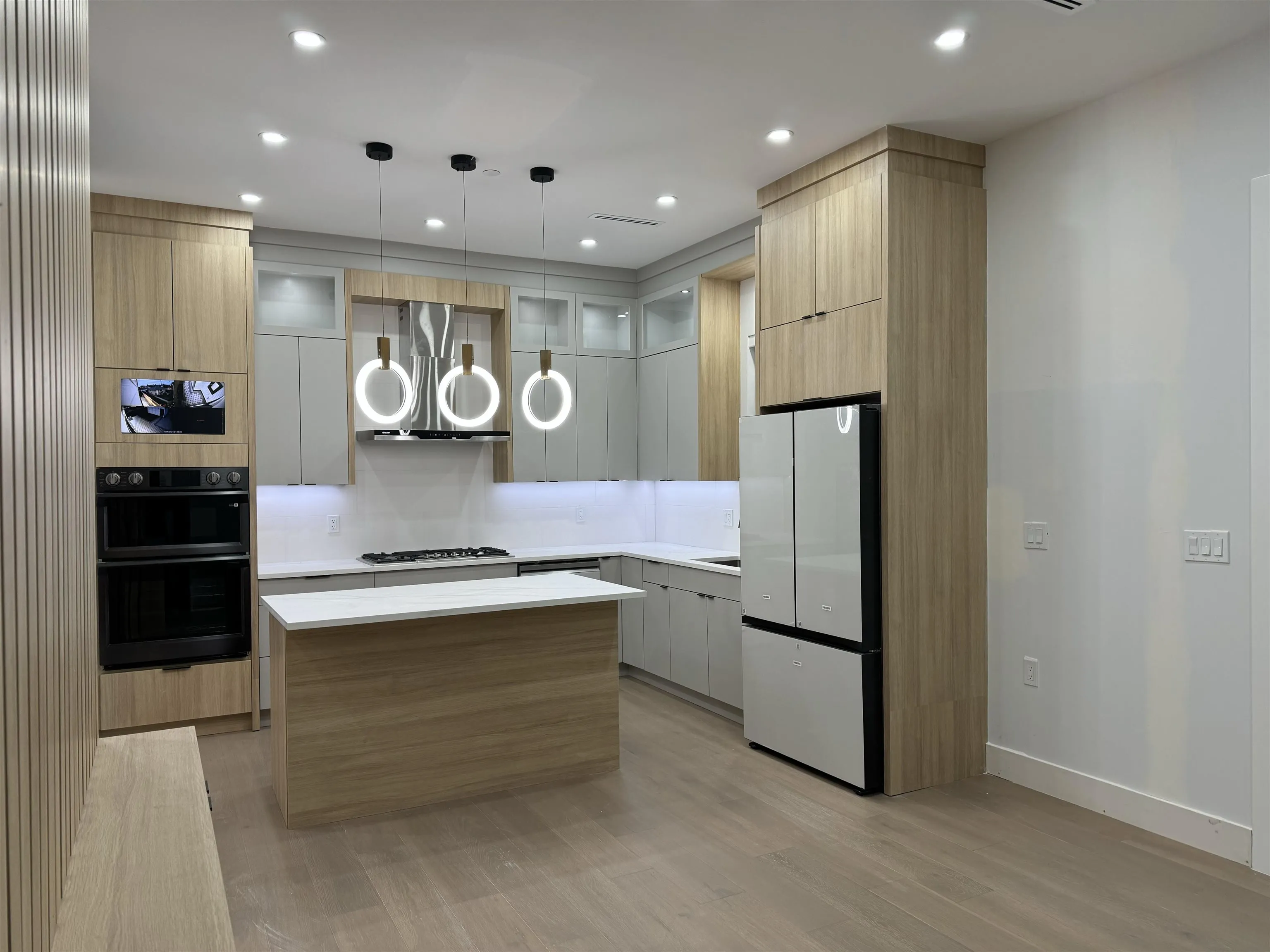 KITCHEN ISLAND IS REPOSITIONED AS SHOWN, APPLIANCES ARE INSTALLED