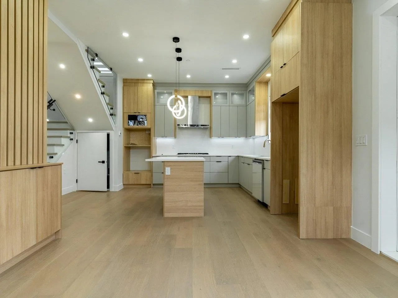 KITCHEN ISLAND IS REPOSITIONED PARALLEL TO STOVE, APPLIANCES ARE INSTALLED