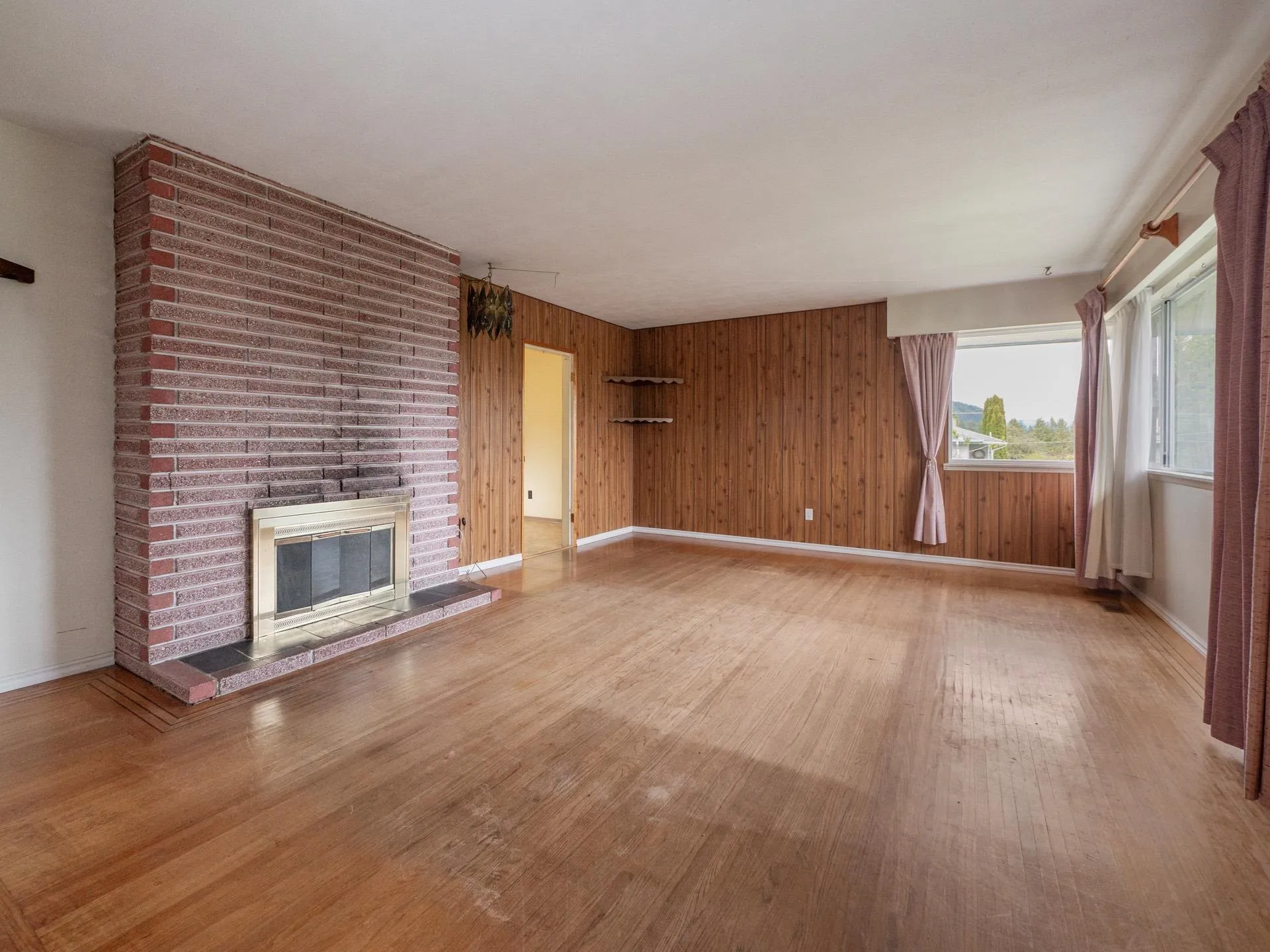 With brick wood burning fireplace and real hardwood floors.