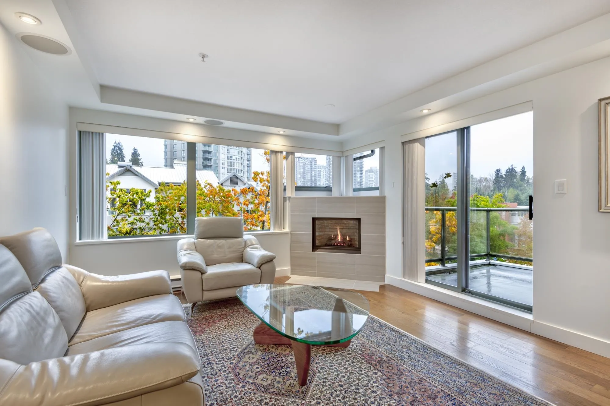 Bright living room with a new gas fireplace with marble surround