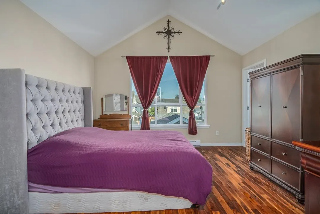 Spacious Primary Bedroom featuring vaulted ceiling and walk-in closet.