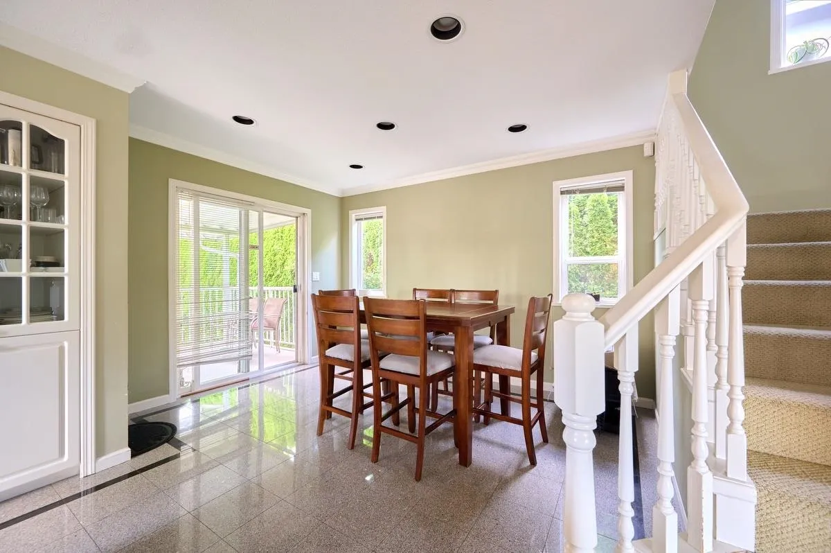 Dining room off the kitchen with sliders to the back covered deck