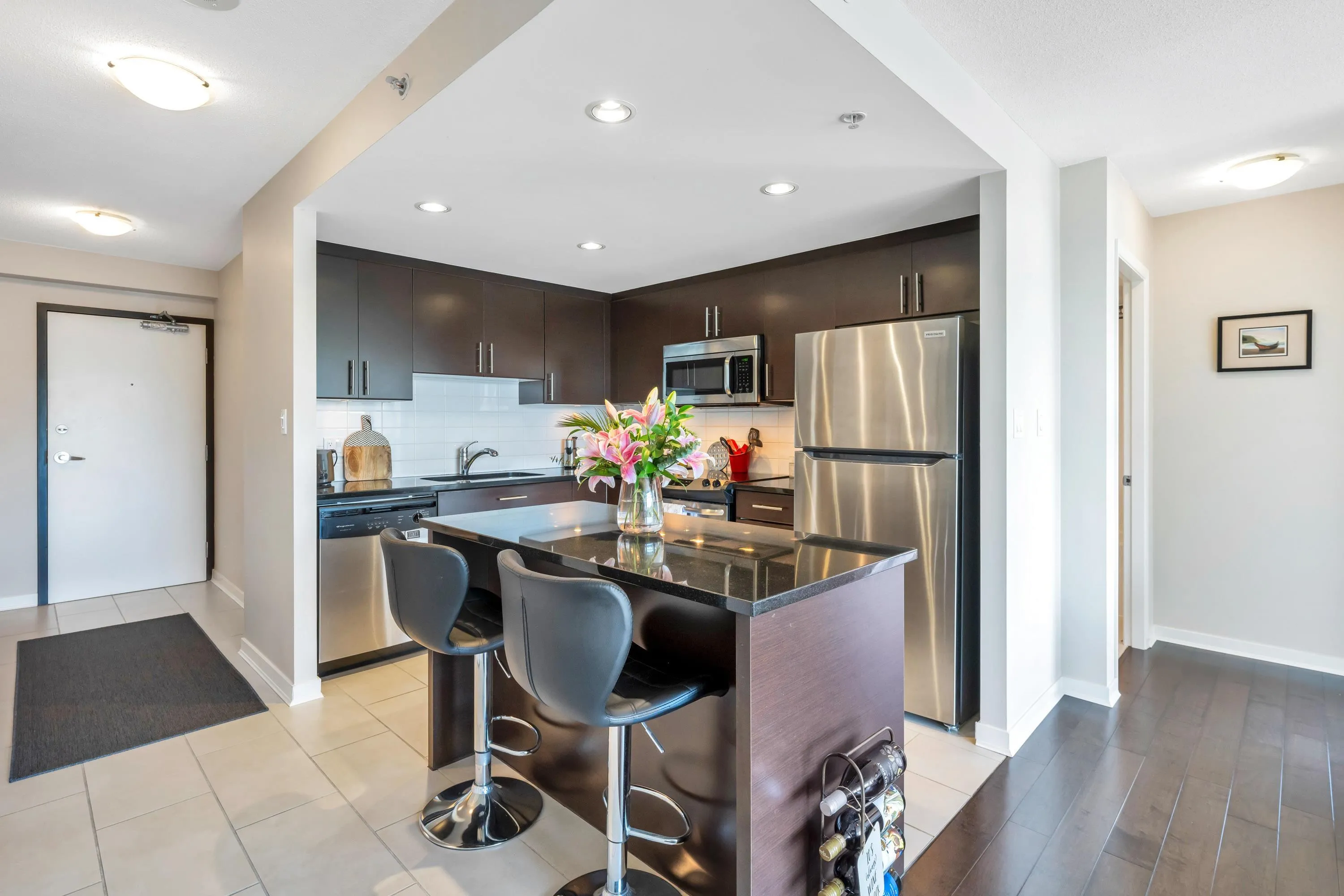 The kitchen features stunning granite countertops and ample storage and prep space.