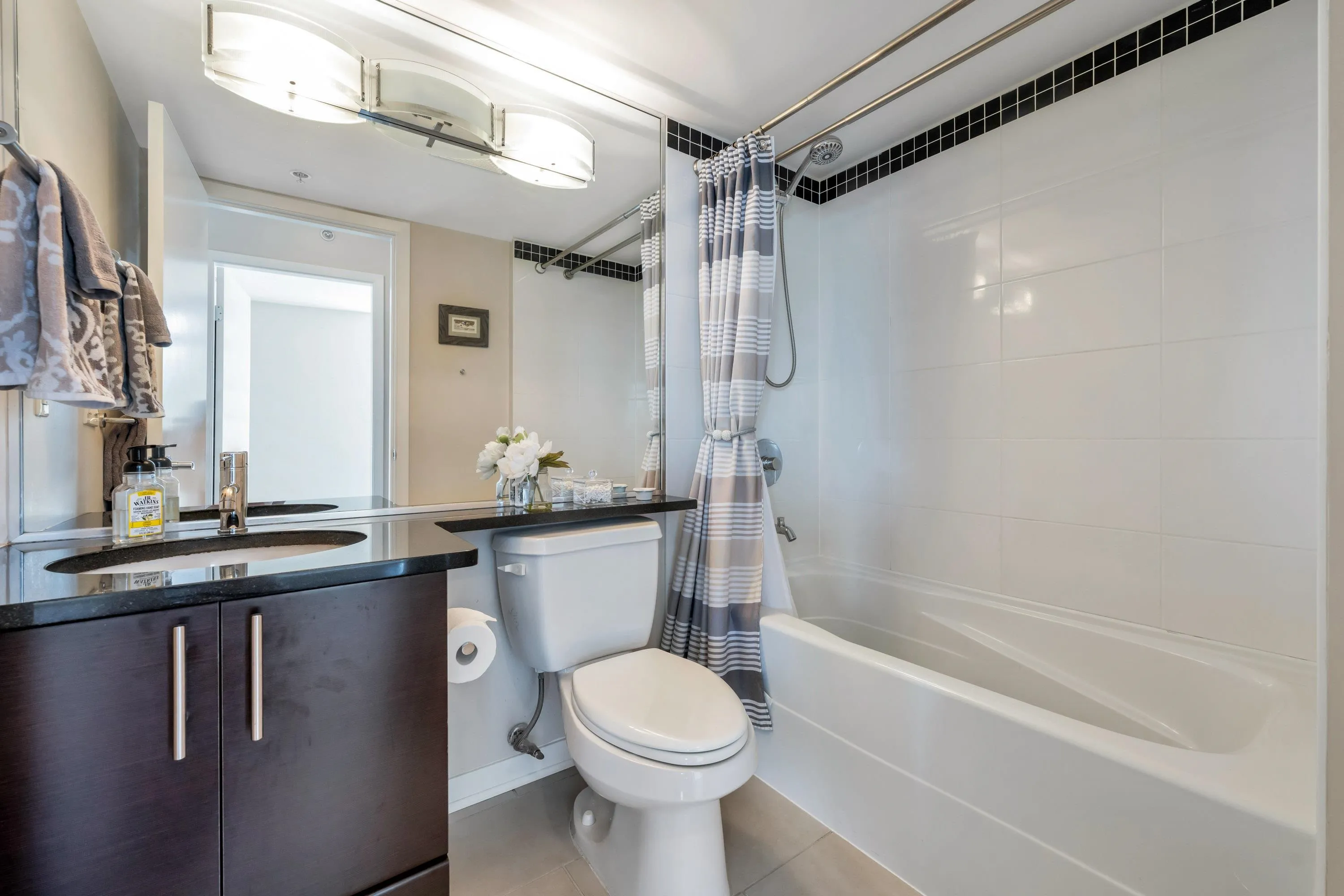 The full sized second bathroom is perfect for guests whether they be long term or short term! Tastefully appointed plus extra storage with the cabinet offers room for linens and cleaning supplies.