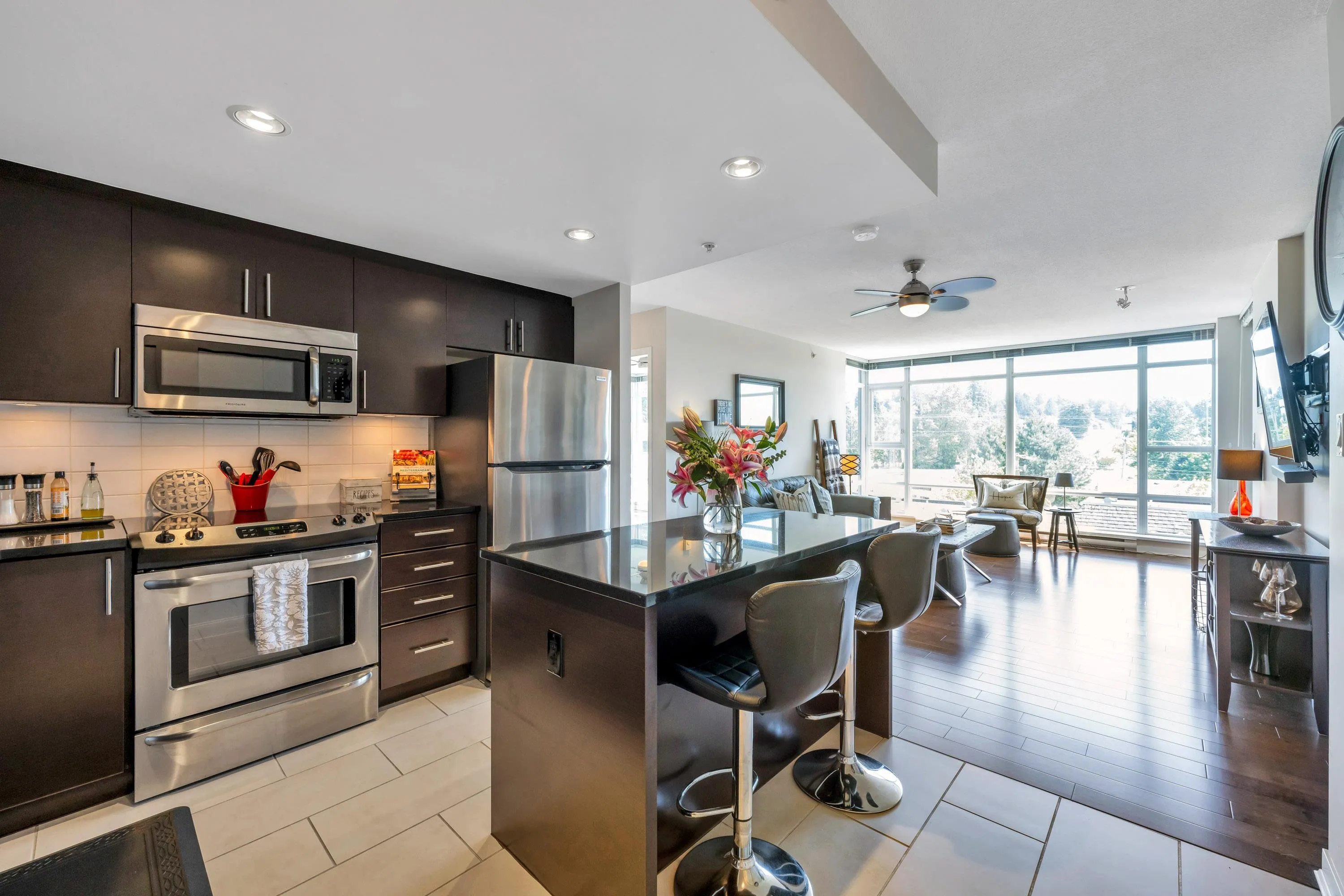 Well designed, well lit with overhead lights, and plenty of work and storage make this kitchen a place you will enjoy spending time in