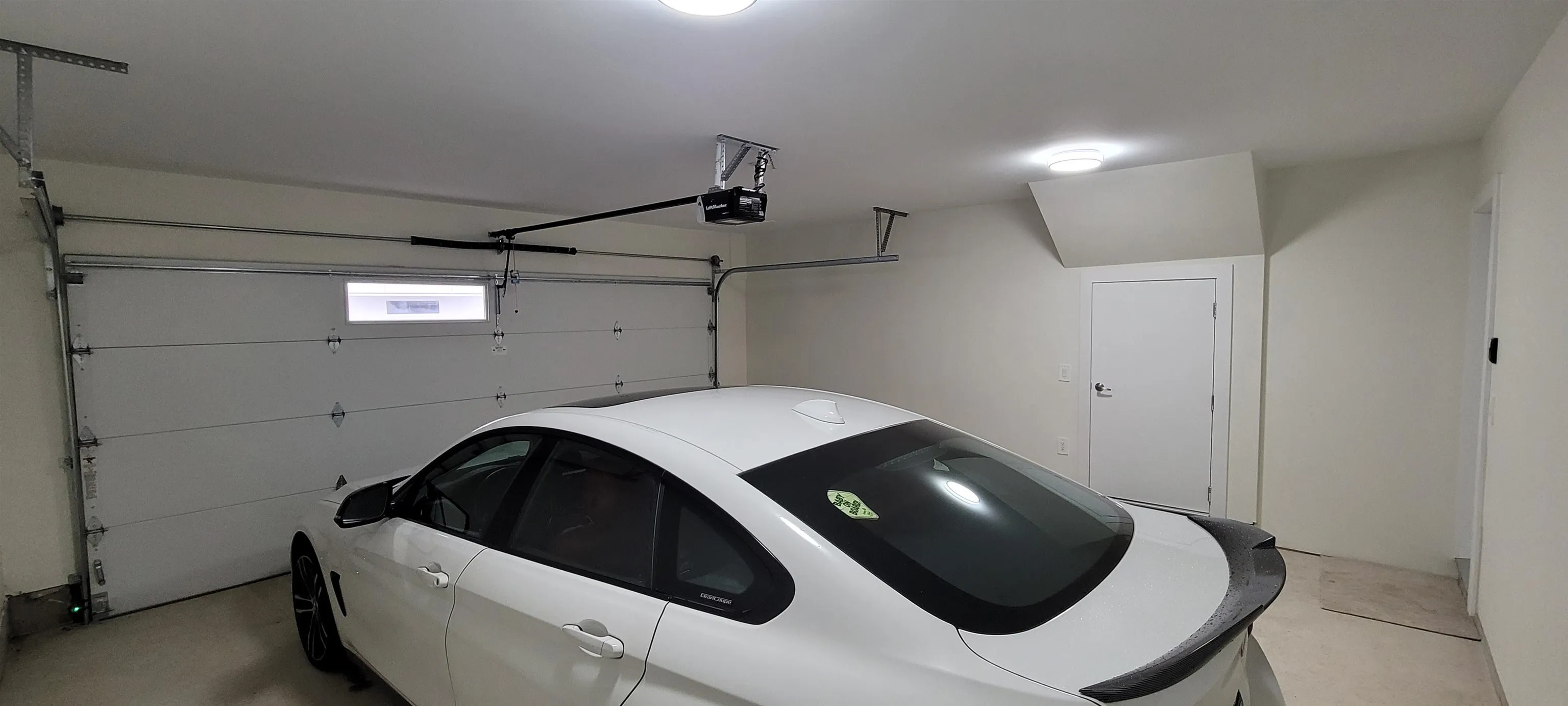 Double car garage with storage room w/ water heater.