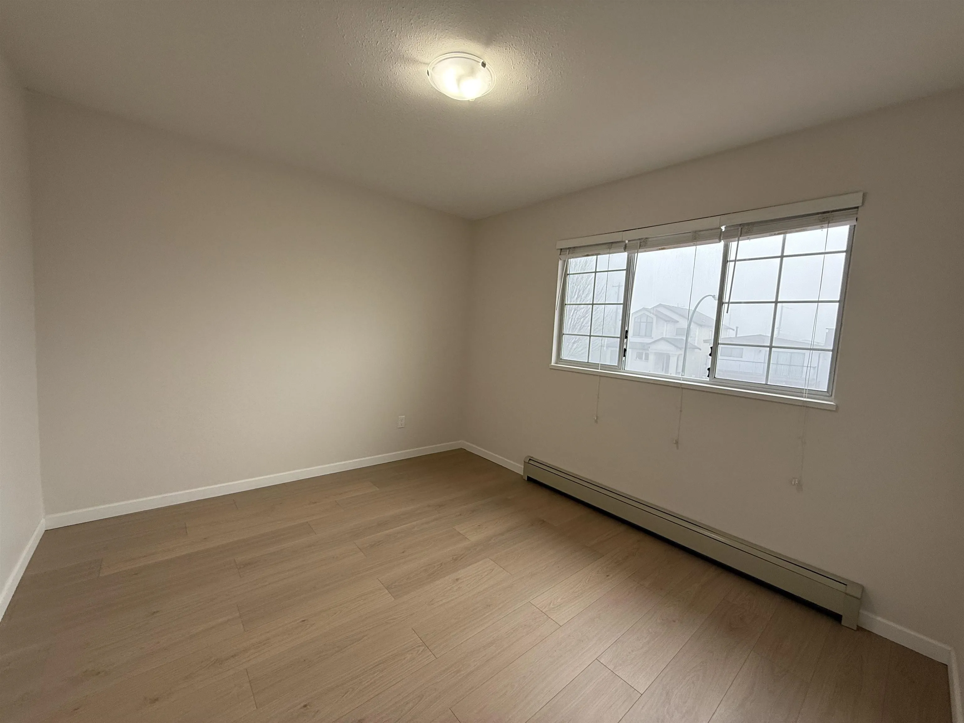 Upper floor bedroom with large windows.